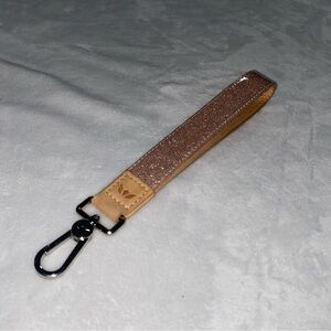 Consuela 
Pink glitter wristlet strap